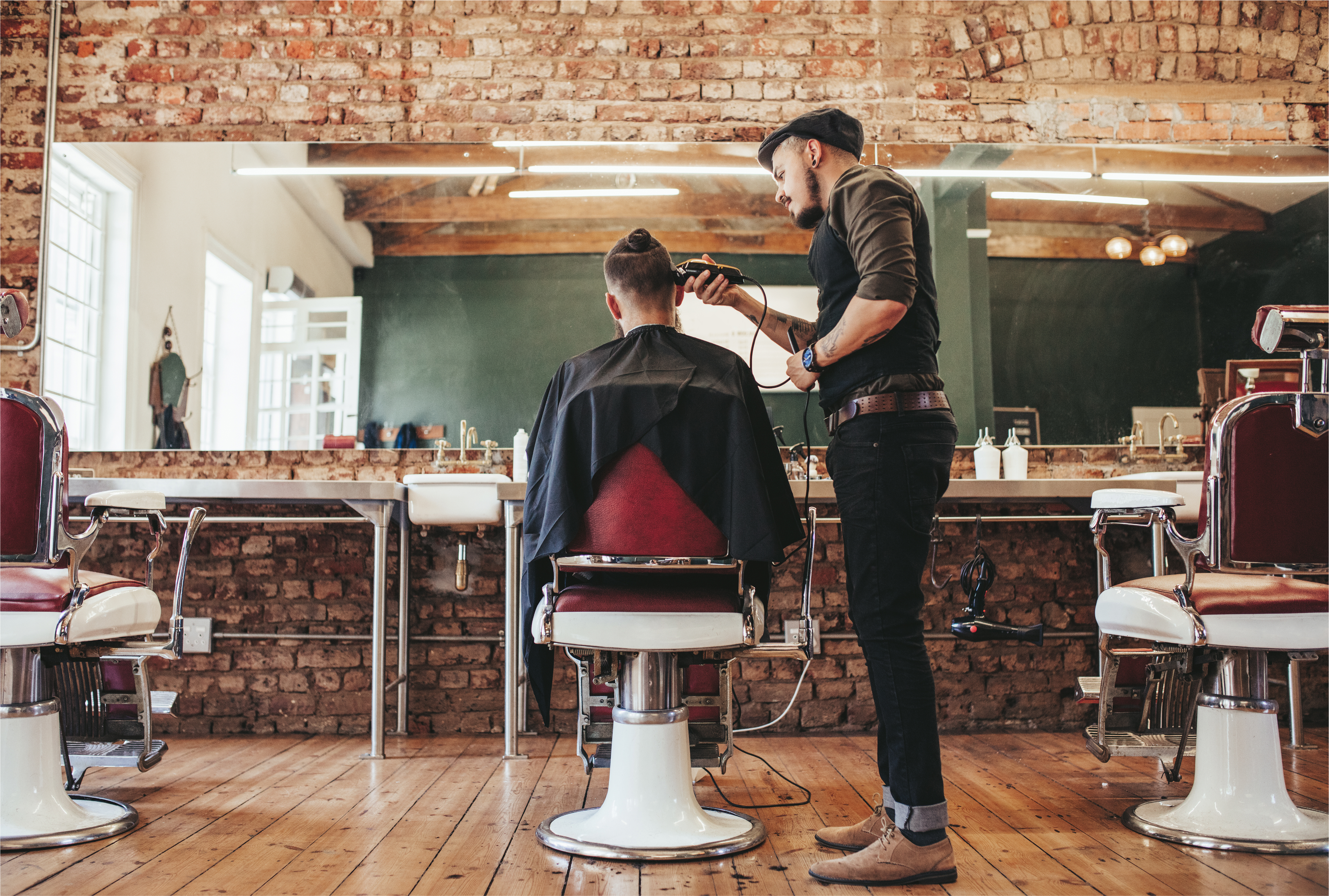 Professional barber cutting client's hair