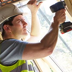 Construction employee using drill