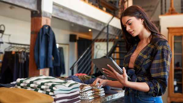 Clothes retailer holding tablet
