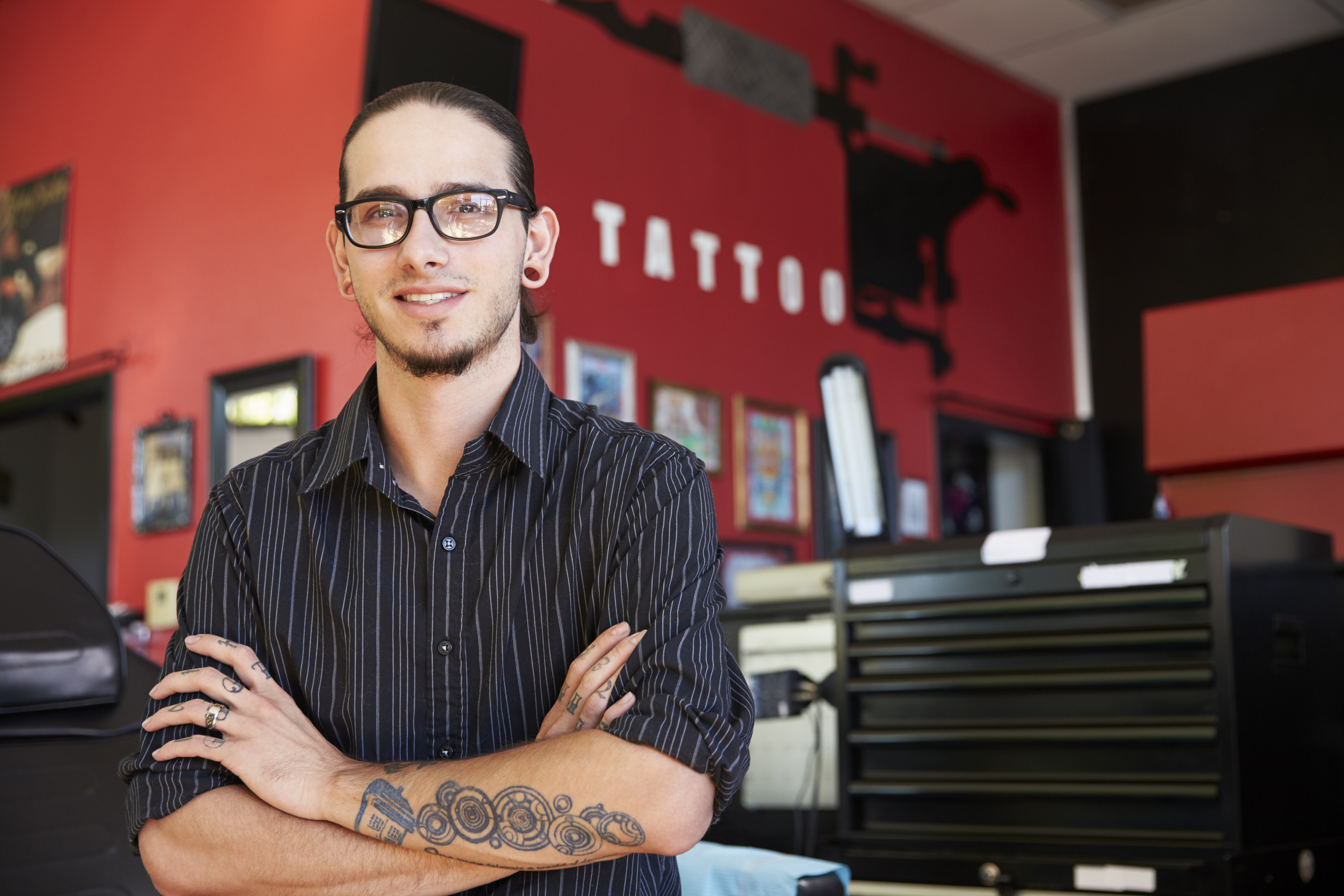 Tattoo parlor owner poses for a photo.