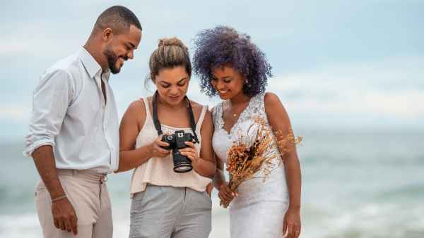 Couple reviewing photos with photographer