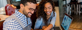 Happy business owner helping an employee