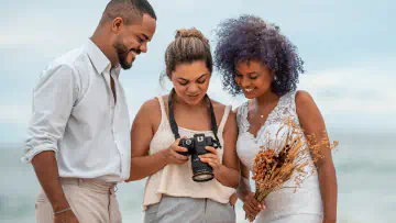 Couple reviewing photos with photographer