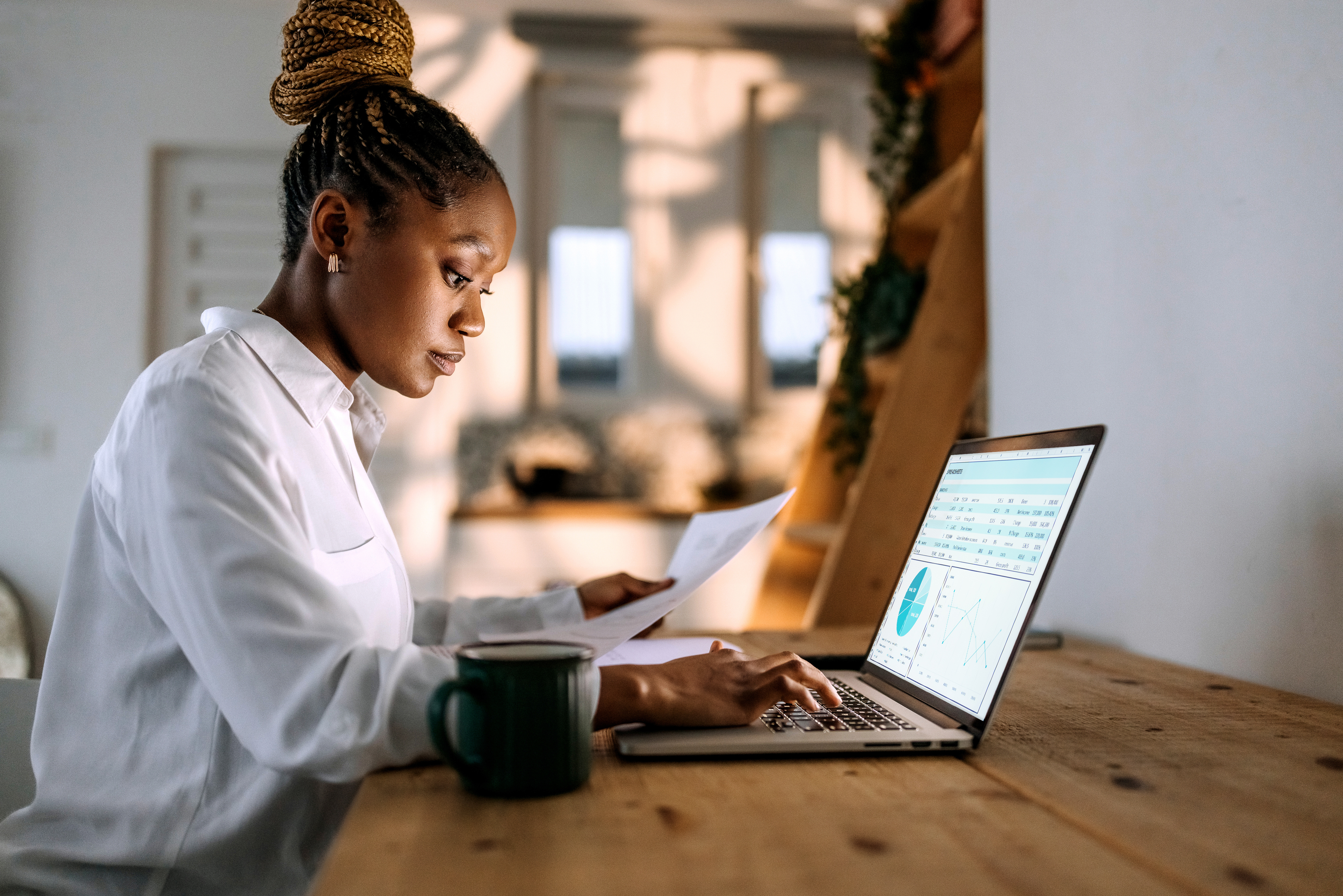 Concentrated young well dressed businesswoman working from home office