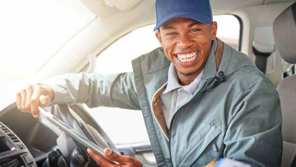 Smiling truck driver looks out the cabin window
