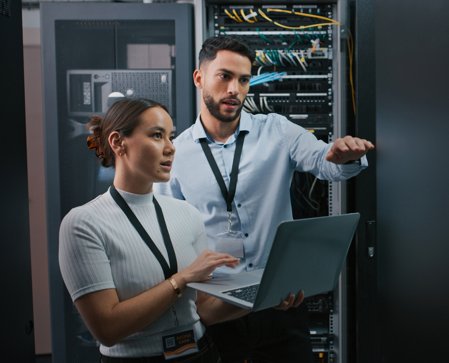 Two IT professionals looking at servers