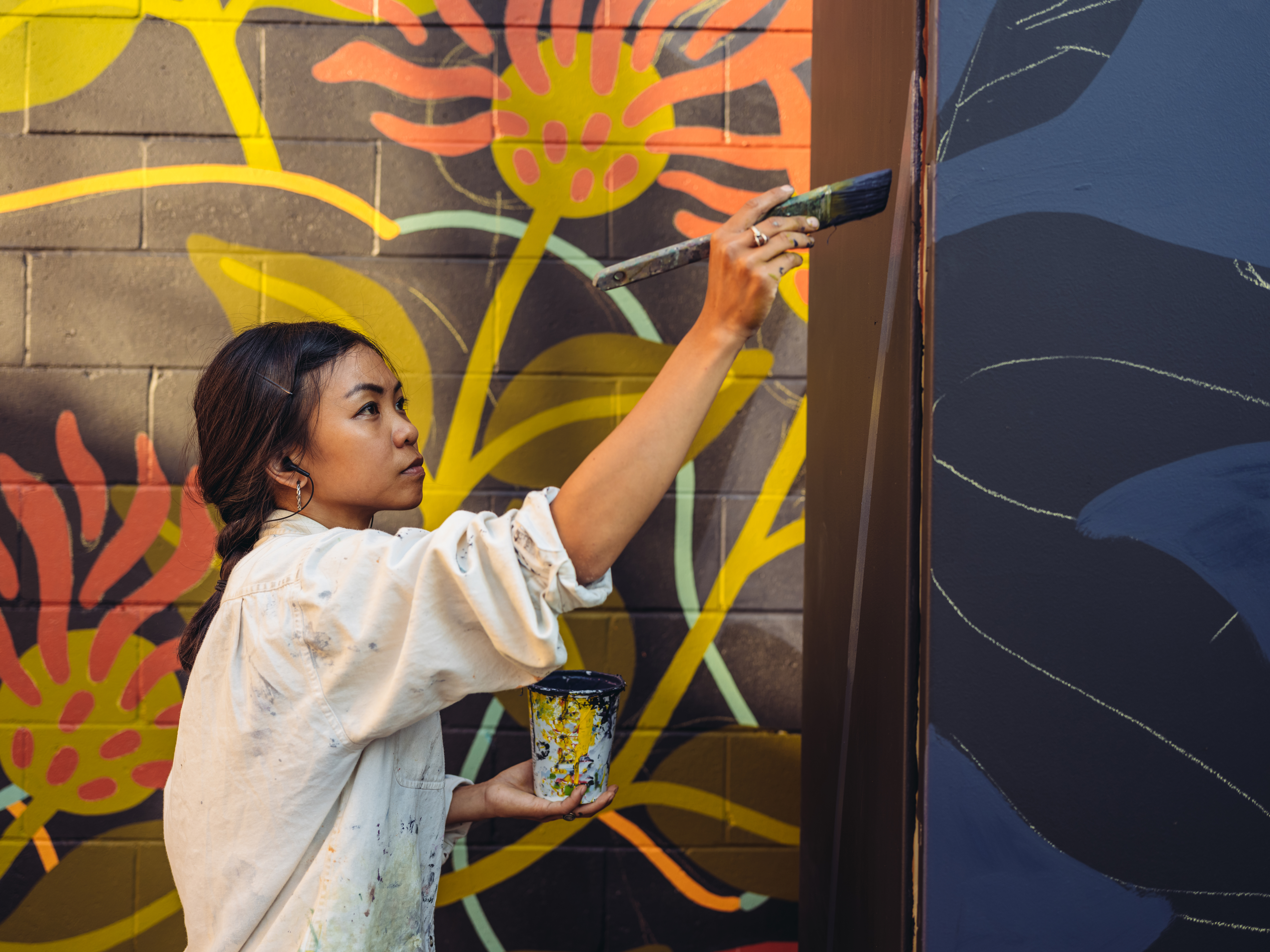 woman painting on a wall