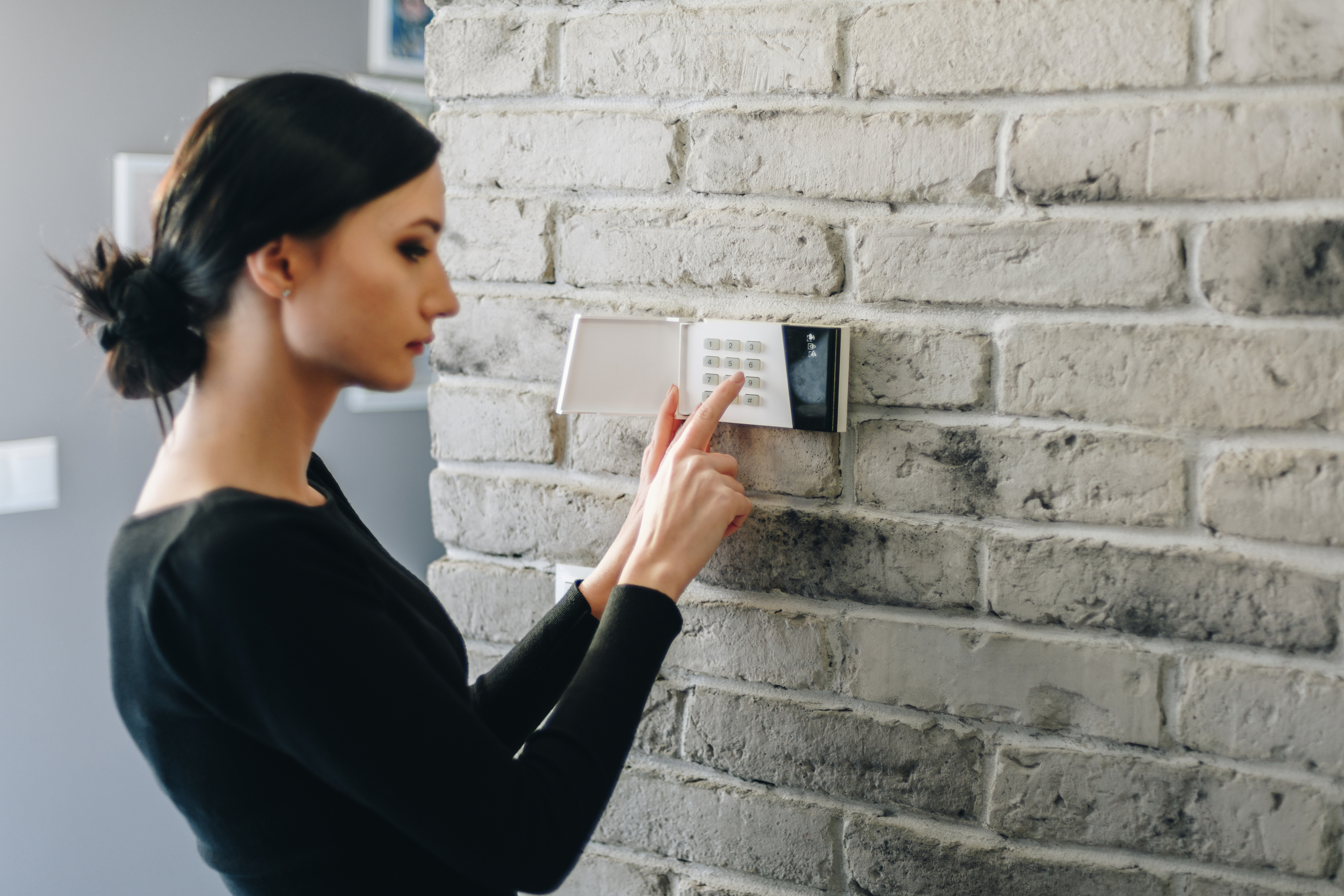 Woman setting alarm