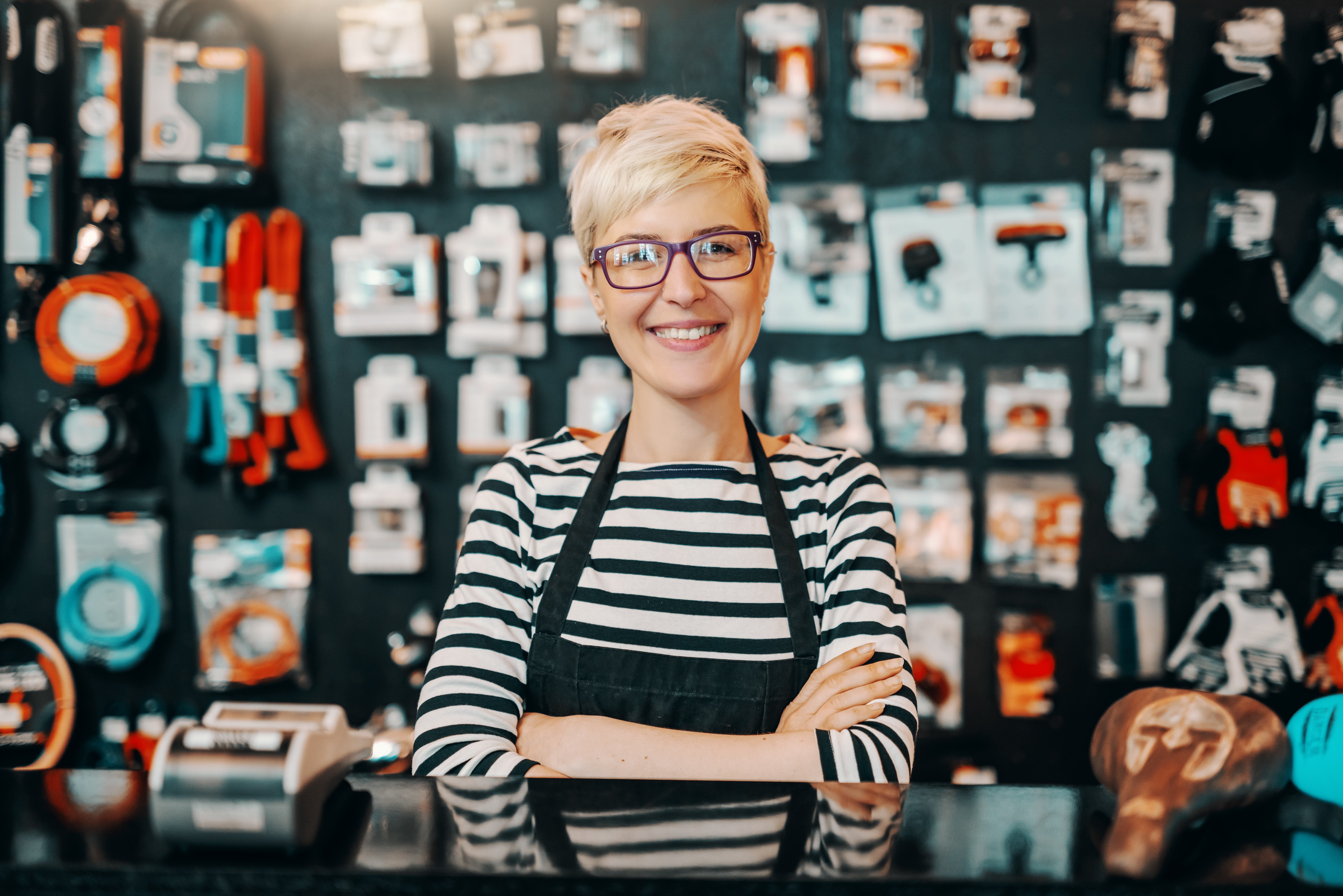 woman with glasses smiling and staring at camera