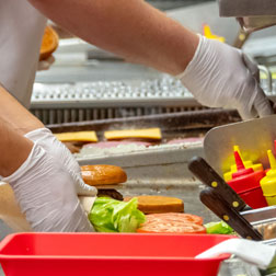 Food court employee making food