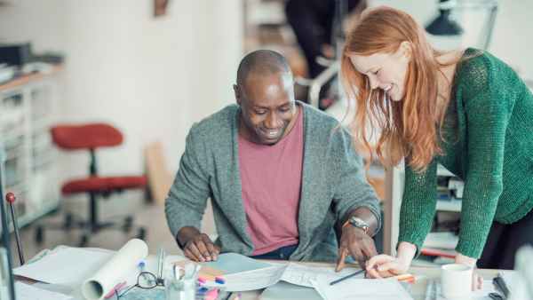 Business owners looking over blue prints