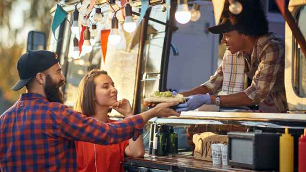 Food truck serves meal to two patrons